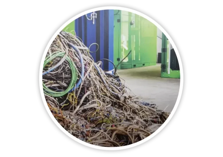 Pile of recycled electrical cables stored inside recycling facility for producing sustainable plastic-rubber composite traffic safety products