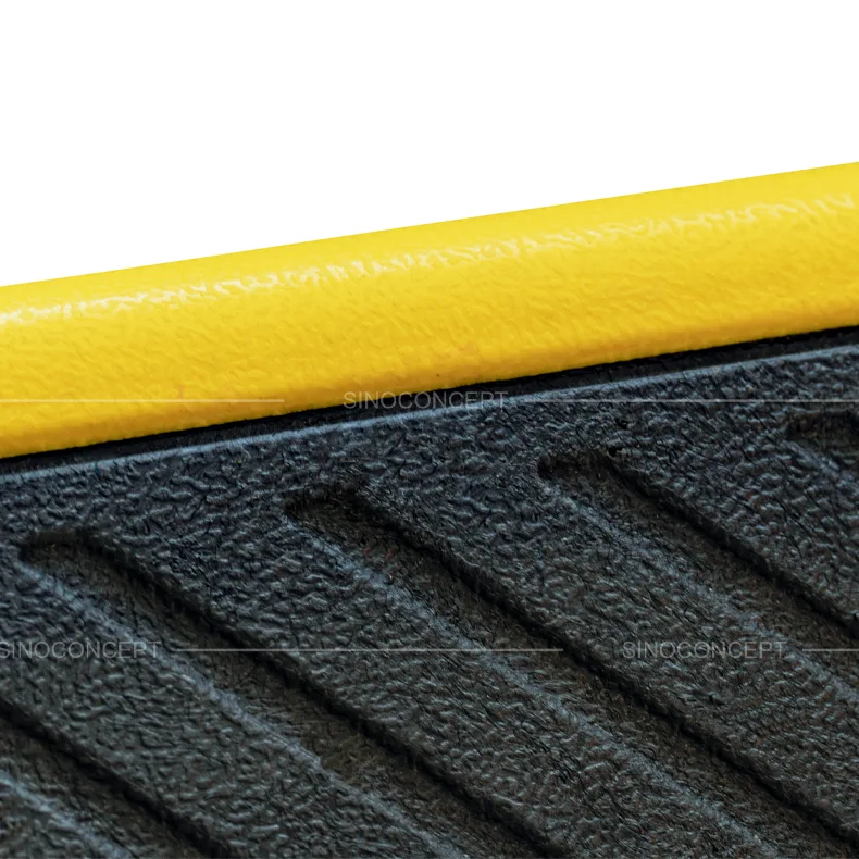 Close-up of moulded-in yellow marking on truck wheel stops for improved visibility in low light and wet conditions