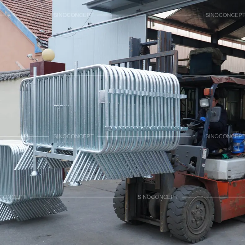 Forklift transporting crowd barrier stillage fully loaded with metal crowd control barriers, designed for easy handling, storage and bulk transport