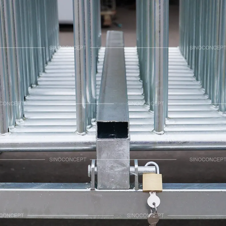 Front view of crowd barrier stillage loaded with crowd control barriers, featuring secure single lock system with brass padlock for safe storage and transport