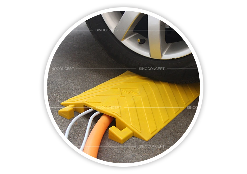 Large drop over cable cover in yellow protecting cables under vehicle wheel