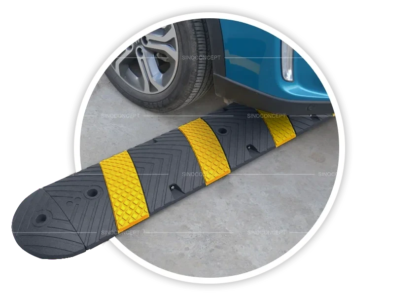 One-part speed bump installed on concrete driveway with car wheel passing for speed control