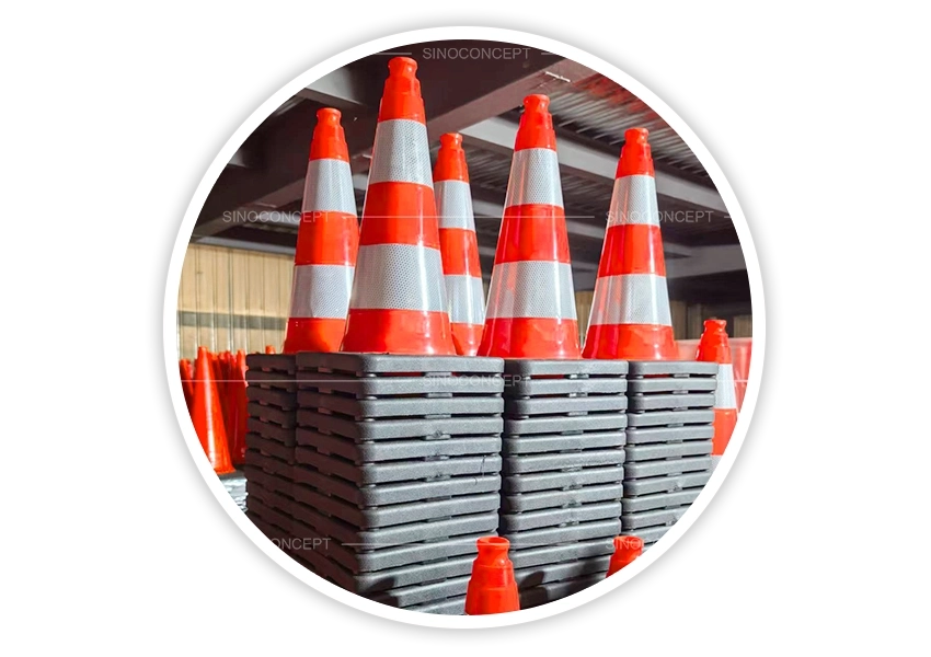 Production line with stacks of orange traffic cones in factory showing injection moulding process before reflective collars are applied