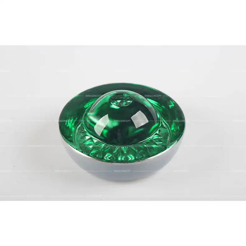Large glass road stud in green for access control areas and specific road guidance applications