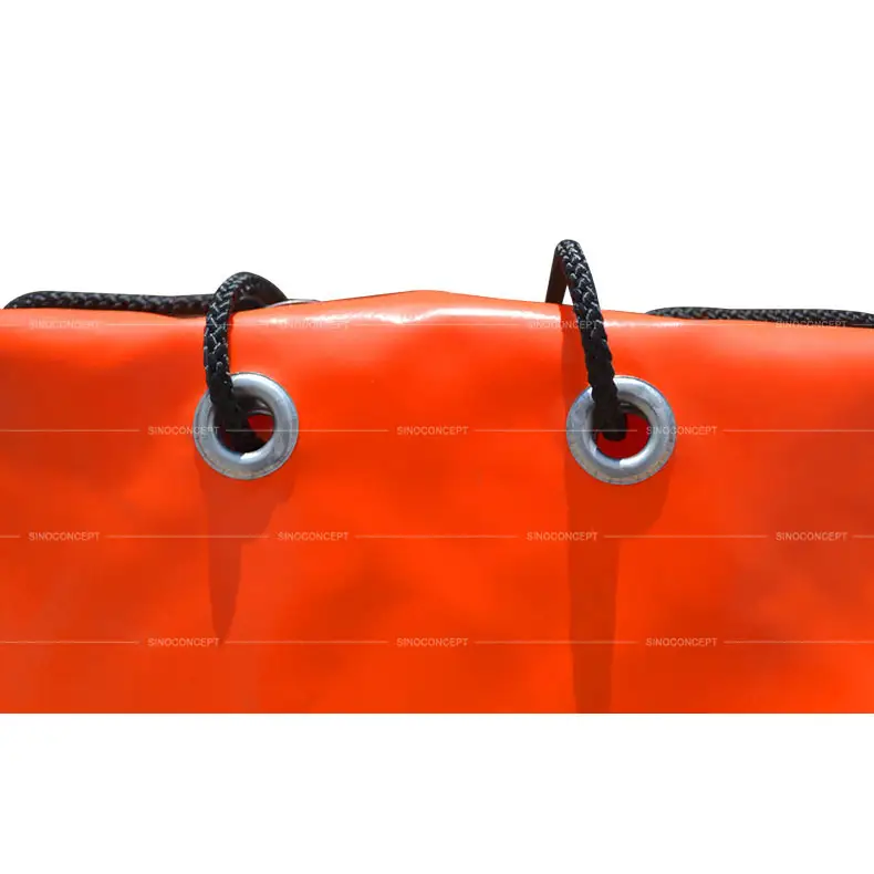 Aluminium eyelets and black strings accessories used on orange PVC sandbag for traffic safety management