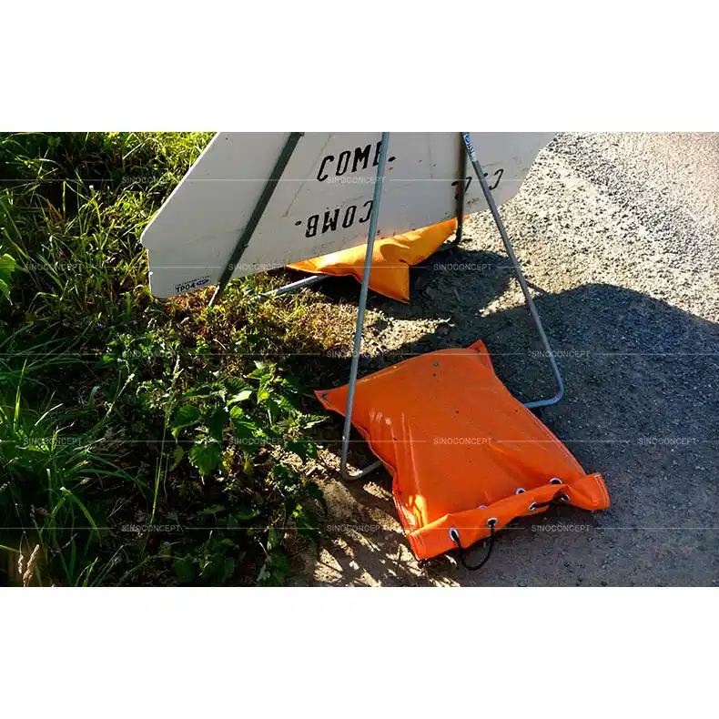 Orange PVC sandbag made of strong UV resistant PVC material used on road to fix signs for traffic safety