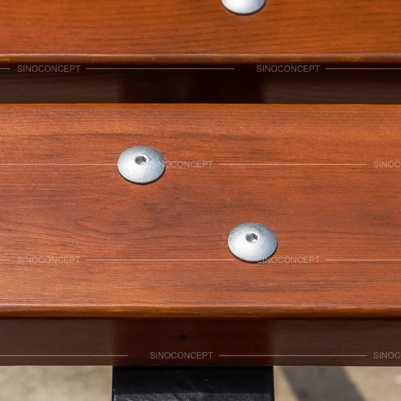 Close-up of 5-slat street bench showing varnished pine wood slats and silver bolt fixings