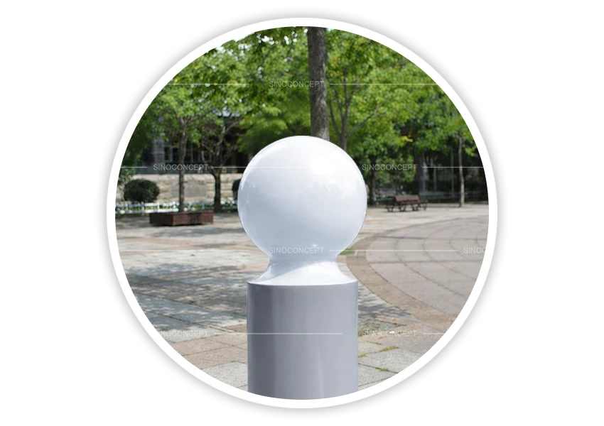 DDA-compliant ball-top bollard with white spherical top installed in paved pedestrian area