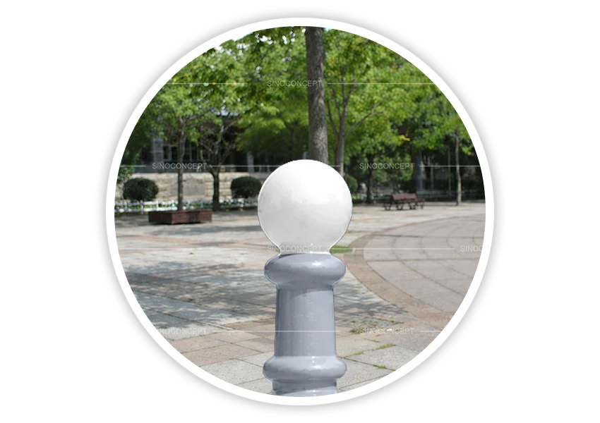 Grey decorative bollard with white ball top installed in pedestrian area for access control