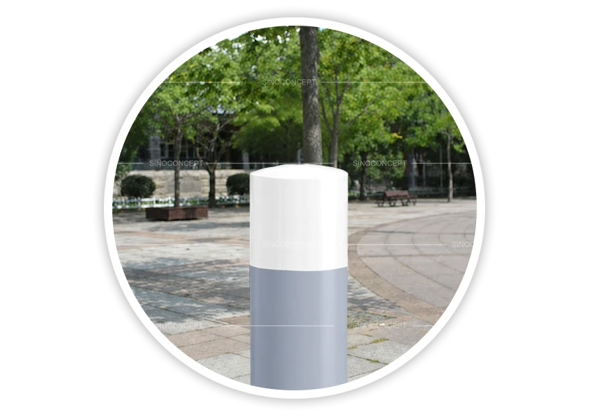 Grey dome-top bollards with white contrasting top installed in pedestrian area for access control