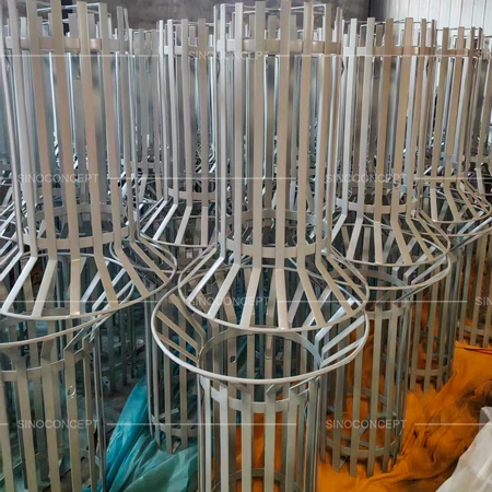 Hot-dip galvanised outdoor litter bins stacked in factory before coating and final assembly