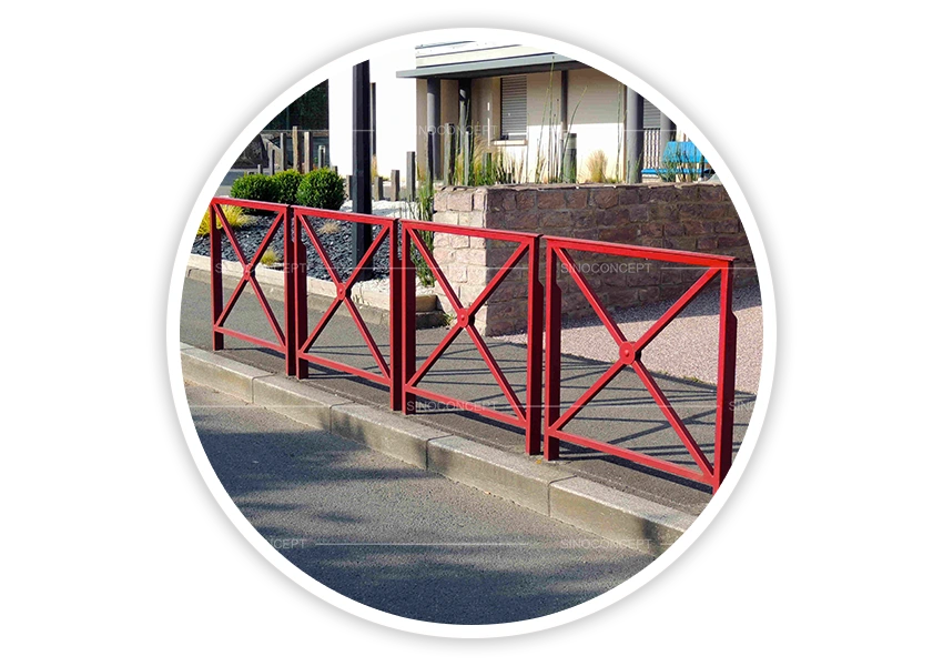 Red pedestrian guardrails installed beside roadside kerb for pedestrian guidance and route separation
