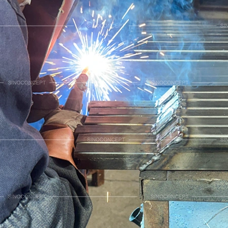 Welded construction of pedestrian guardrails showing mild steel tube joints during production