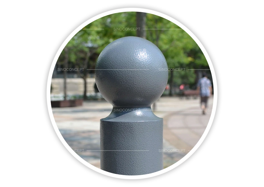 Close-up of grey street bollards showing round ball top and textured coated finish