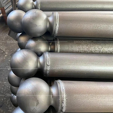 Steel street bollards with round ball tops stacked before surface coating or final installation