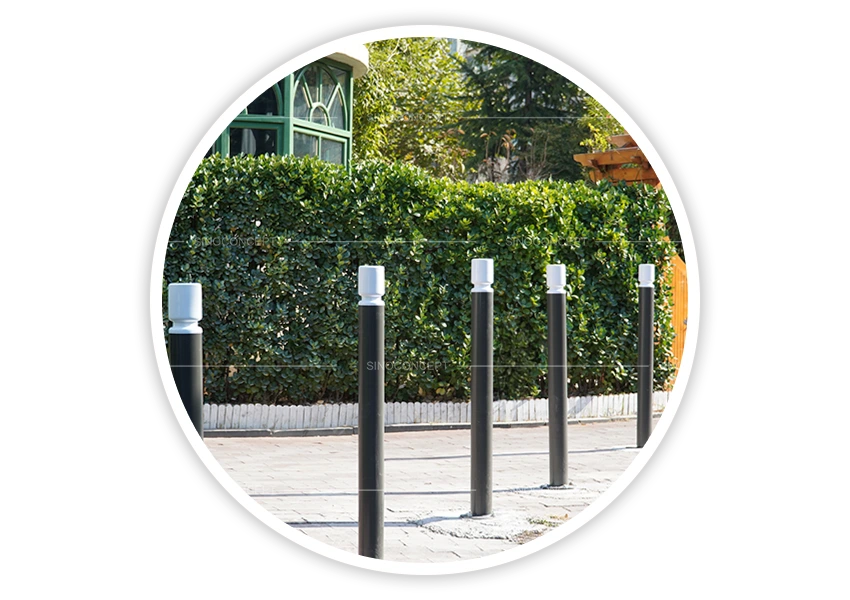 Black street bollards DDA-compliant version installed along pavement for pedestrian area protection
