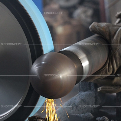 Steel street bollard being machined to form a rounded decorative top