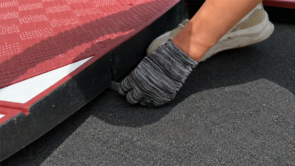 Connecting speed cushion sections using H-connectors to align and secure modular speed cushion parts before fixing.