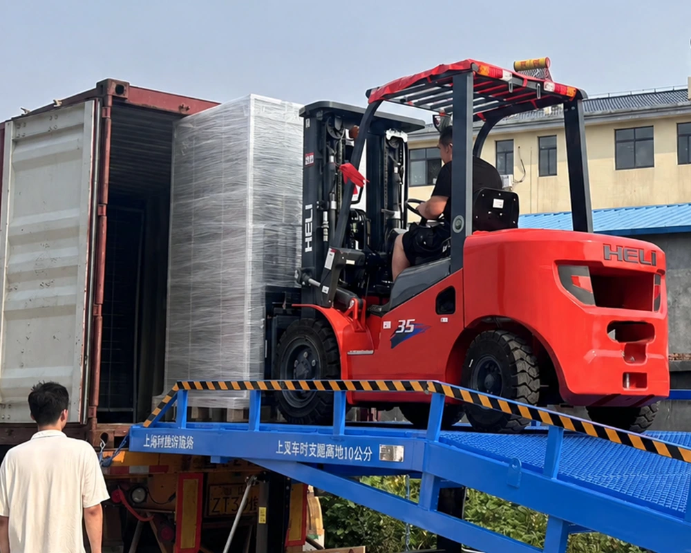 Forklift loading palletised goods into a shipping container for export from China