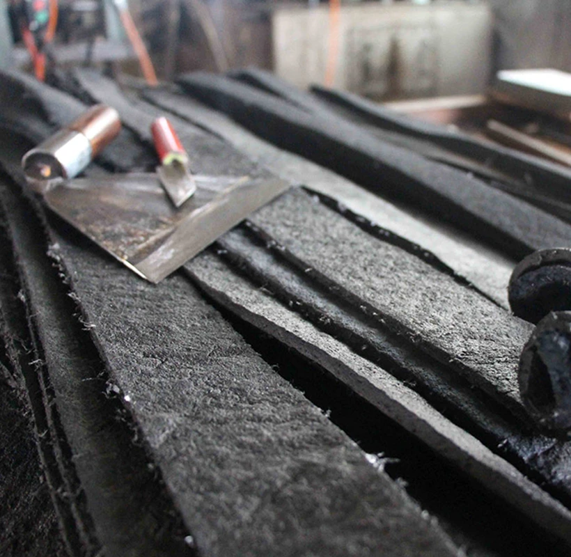 Rubber speed bump manufacturing process showing moulded rubber material during production