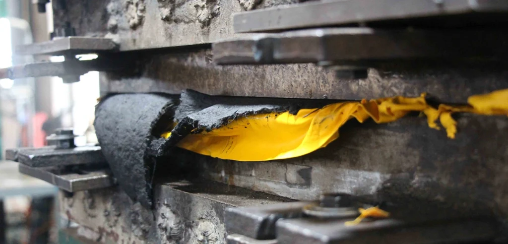 Vulcanised rubber moulding process showing rubber material formed under heat and pressure