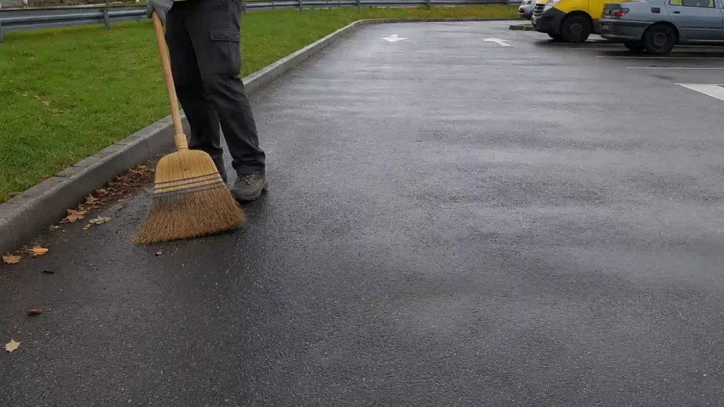 Preparing asphalt surface before speed bump installation in a car park
