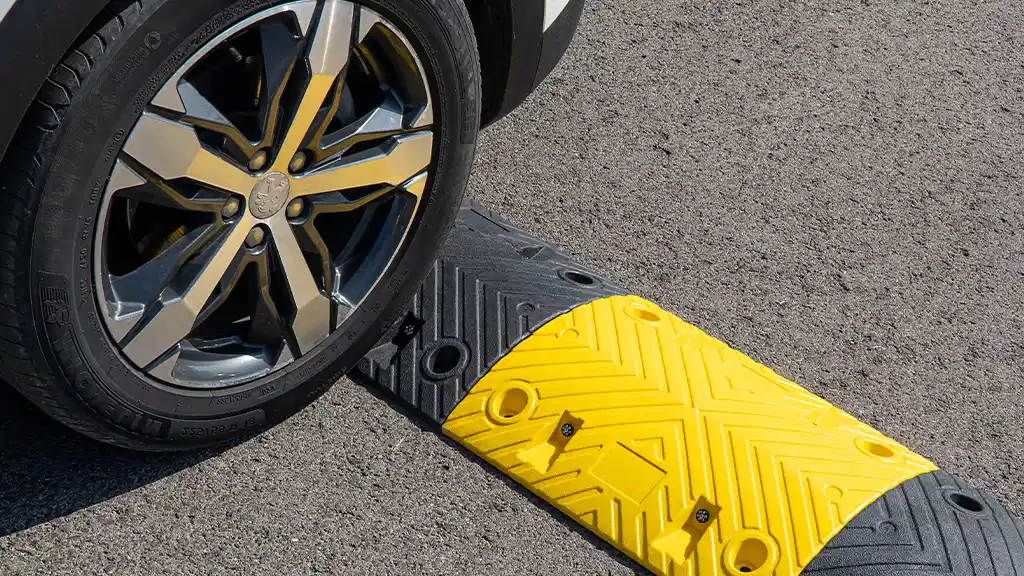 Yellow and black speed bump installed for vehicle traffic control