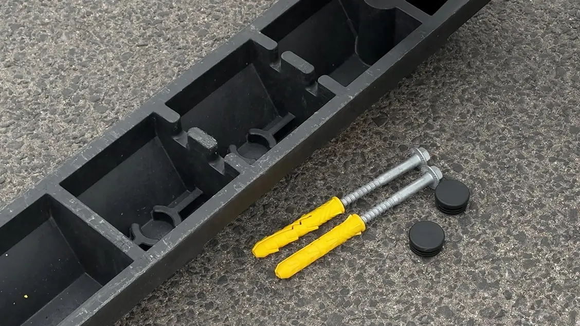Wheel stop fixing hardware including screws, plastic anchors and caps for installation